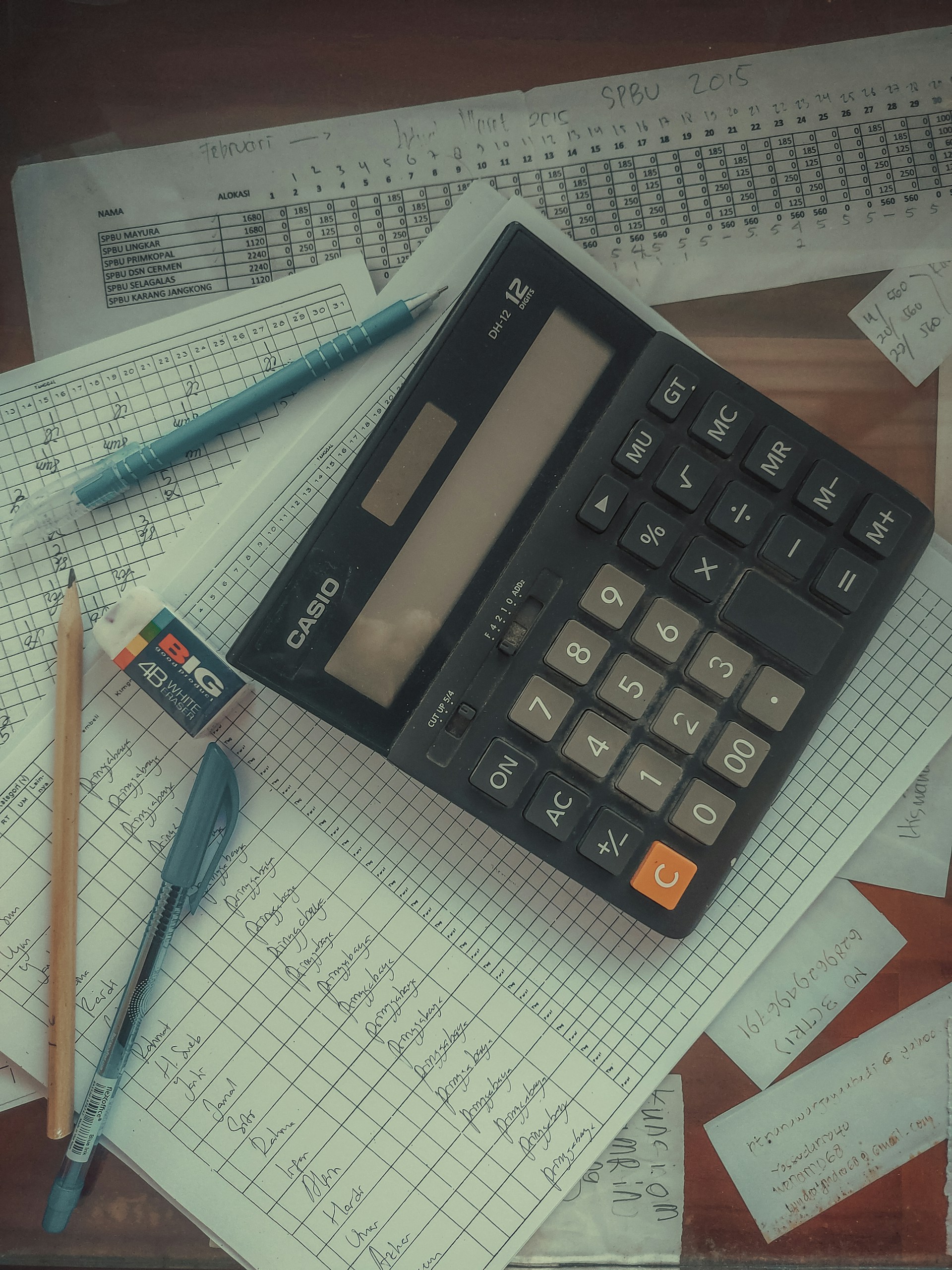 Calculator on desk with papers